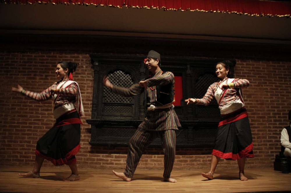 Folk dancers mid-performance on the restaurant stage