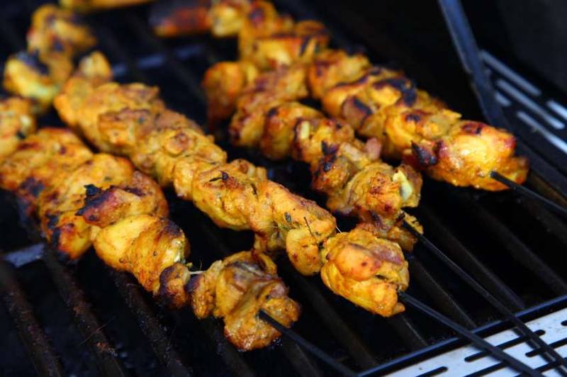 Chicken sekuwa skewers on the grill